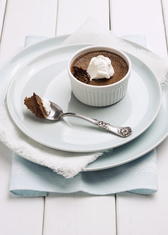 chocolate pots de creme  with a spoonful being eaten