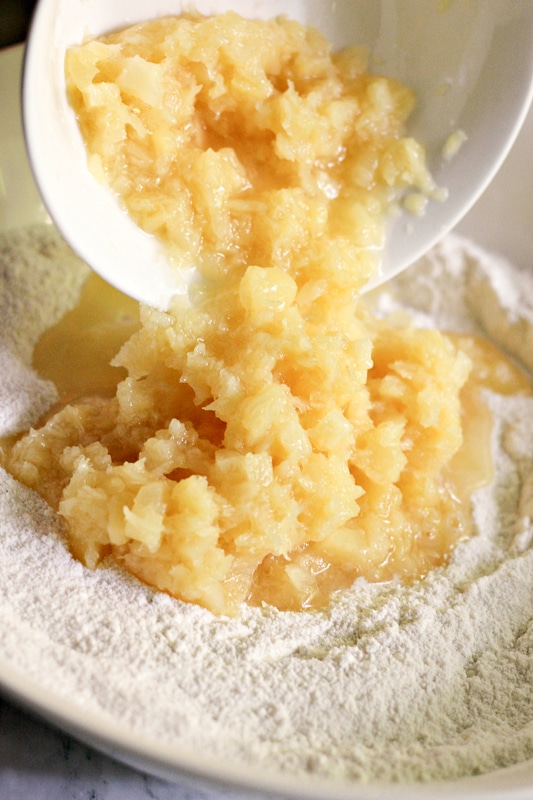 adding pineapples to the cake batter