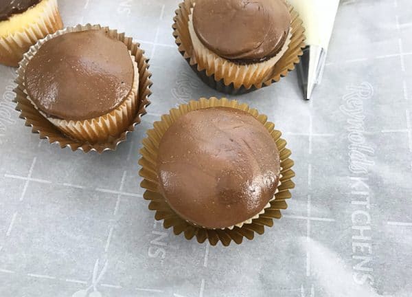 adding tootsie roll tops to football cupcakes