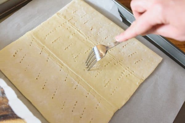 poking holes in a sheet of puff pastry