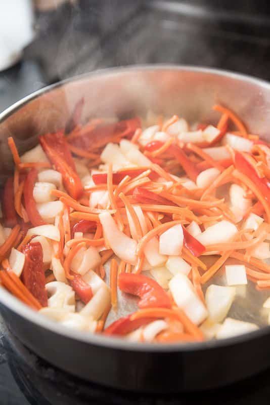 cooking veggies for vegetarian green curry noodles