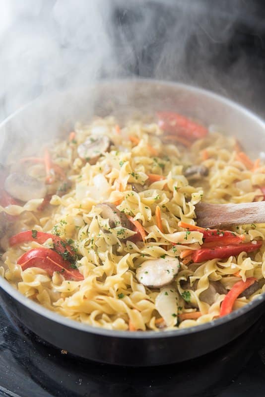 vegetarian green curry noodles cooking on the stovetop