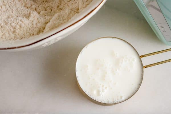 measuring the buttermilk for easy buttermilk biscuits