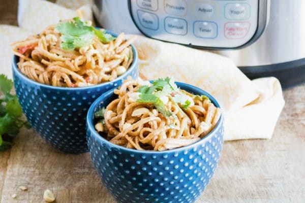 thai peanut noodles in blue serving bowls