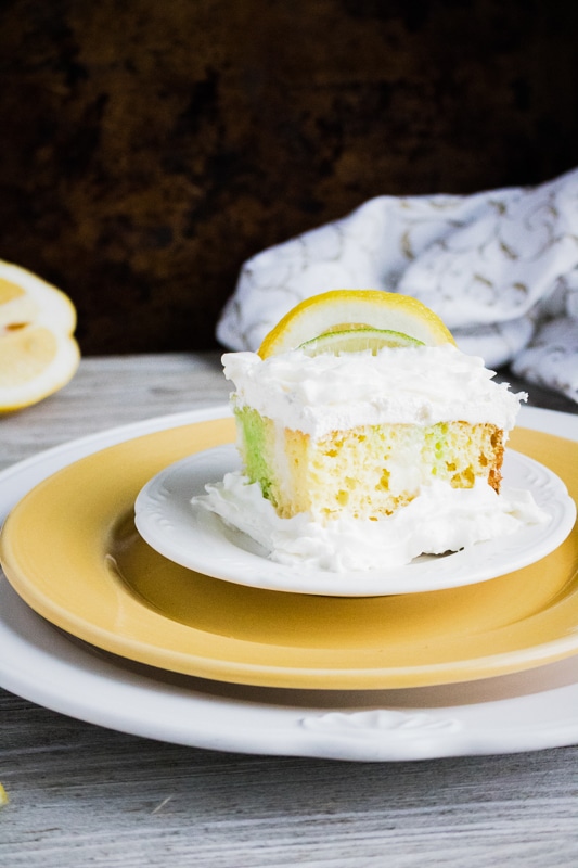 lime and lemon poke cake on a yellow dish