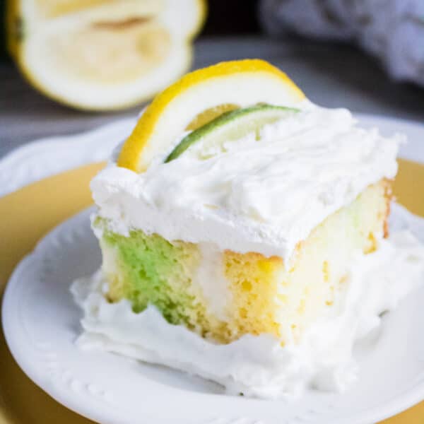 lime lemon poke cake on a serving plate