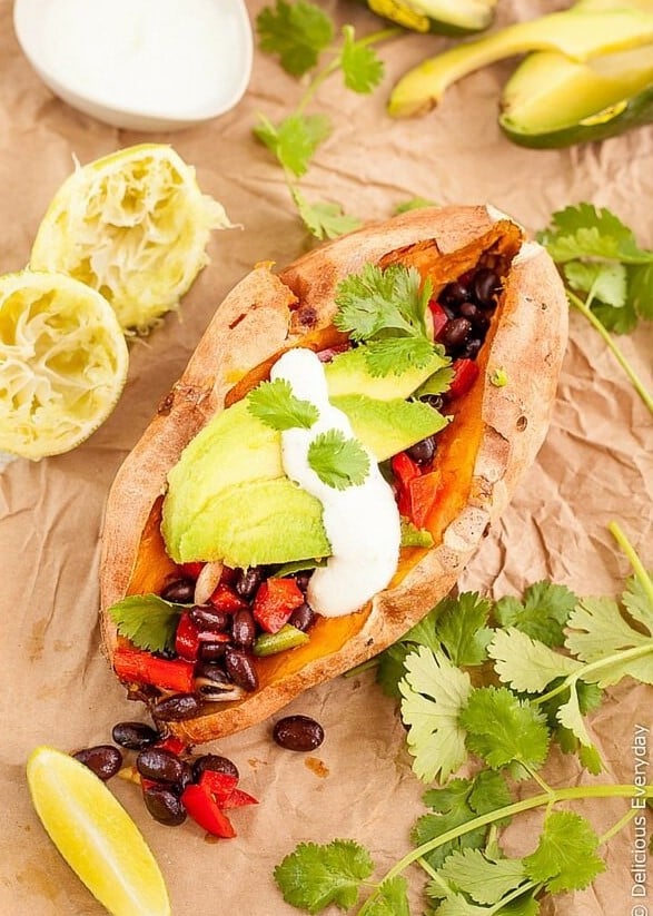 loaded sweet potato with spicy black bean topping being served