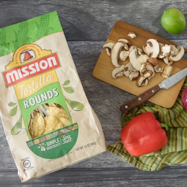 tortilla chips and veggies on a cutting board