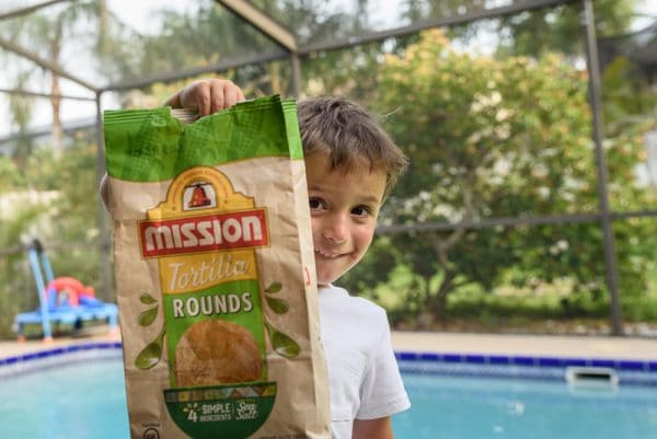 boy with a bag of tortilla chips for nachos