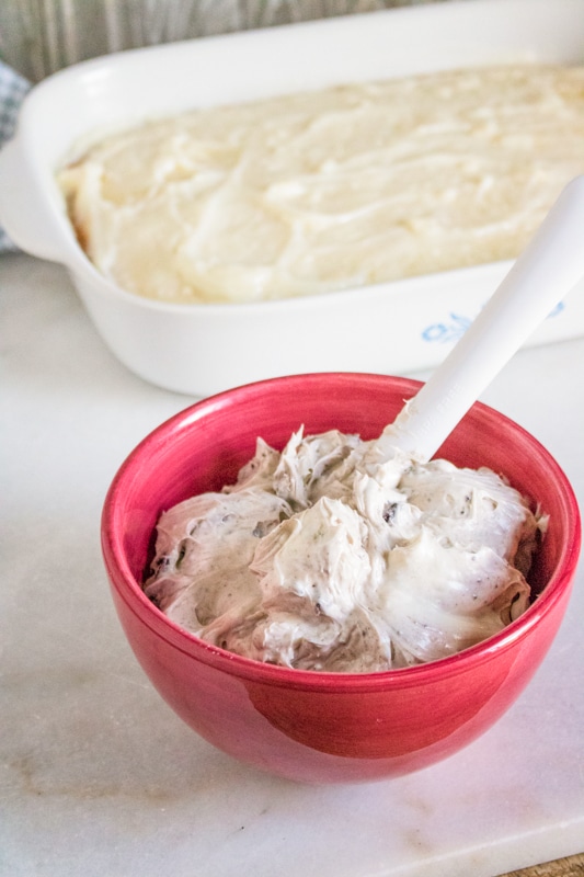 mixing cream cheese icing for the oreo poke cake