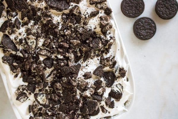 crushed oreos on top of oreo poke cake