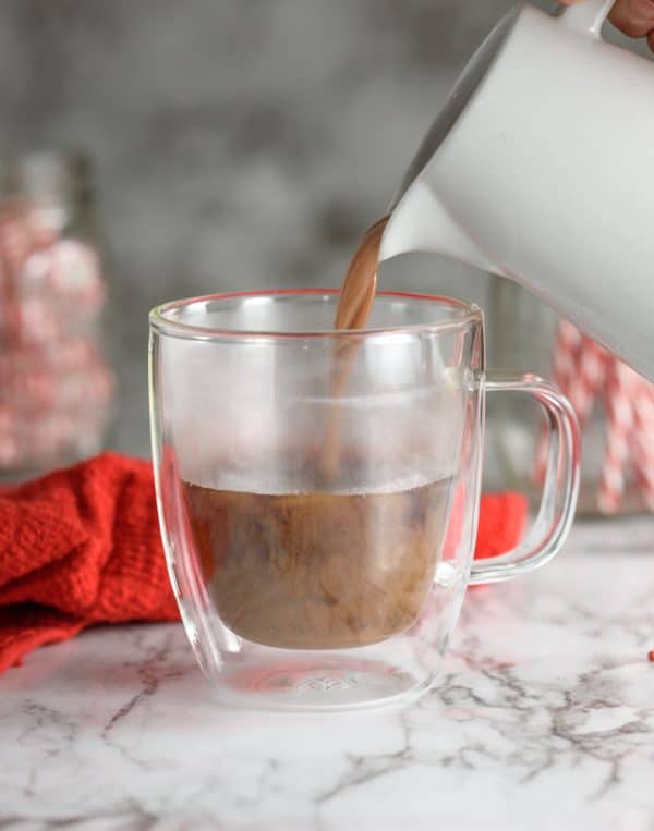 pouring hot chocolate into mug for peppermint chocolatte