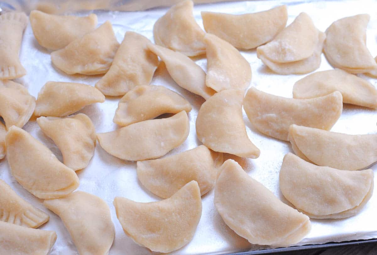 homemade pierogies dough on a baking tray