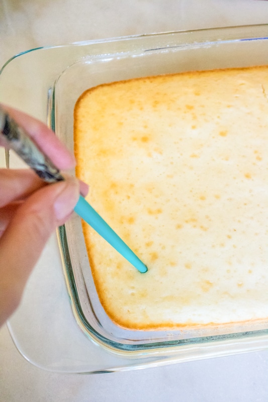 poking holes in pina colada cake