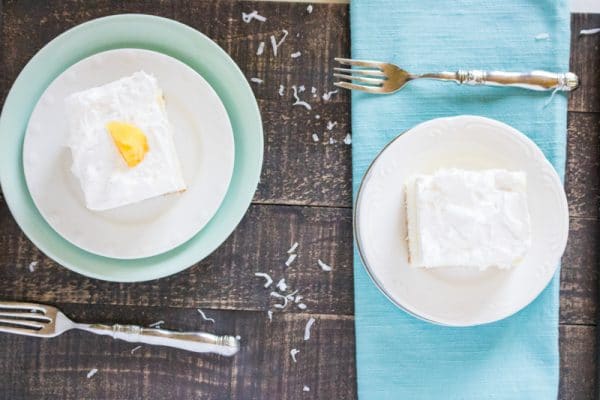 pina colada poke cake being served on plates