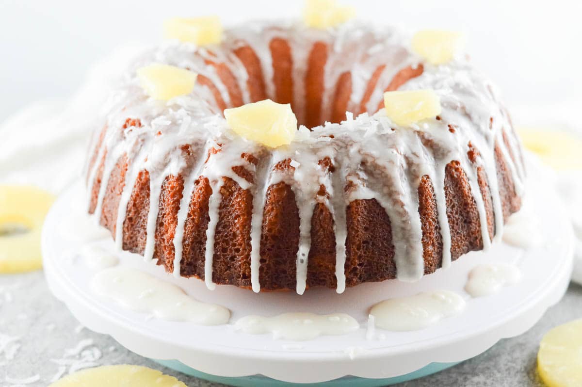 pineapple coconut bundt cake being served on a white tray
