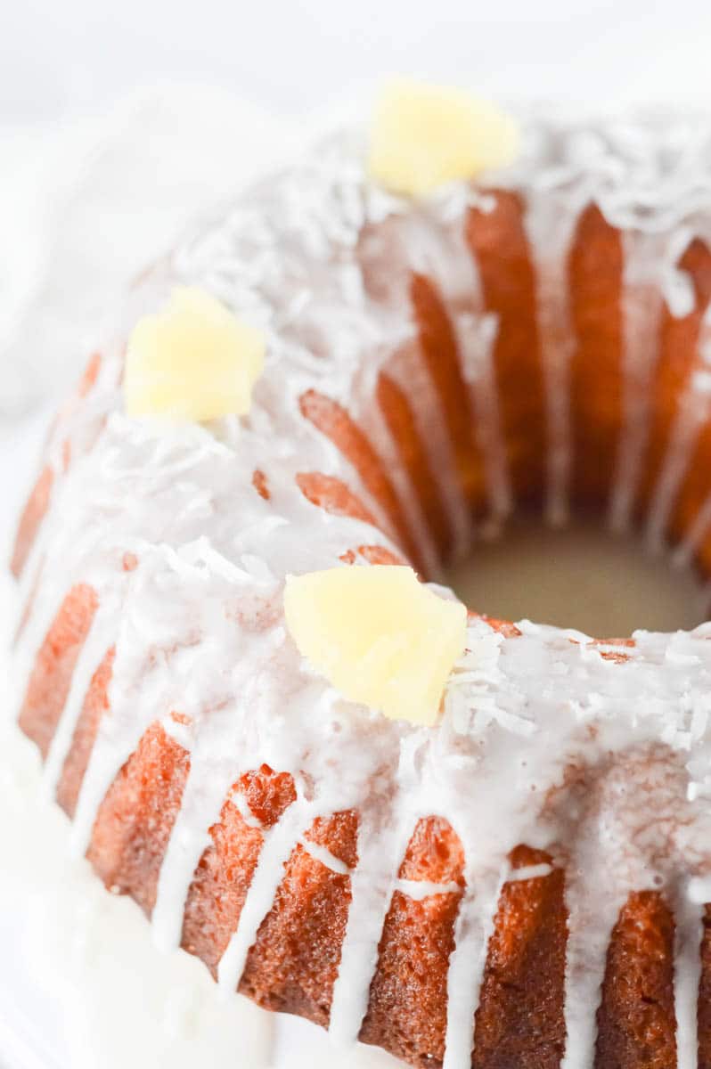 Pineapple Coconut Cake topped with pineapple glaze and fresh pineapple bites.