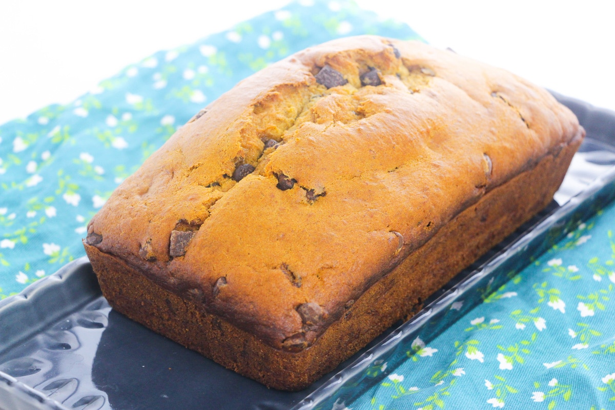 unsliced loaf of pumpkin banana bread with chocolate chips