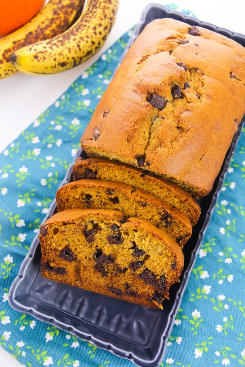 loaf of pumpkin banana bread with chocolate chips with a few slices cut out