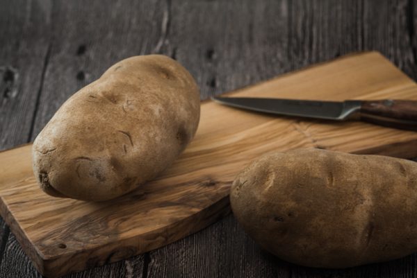 russet potatoes on a cutting board