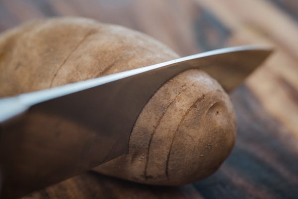 slicing a hasselback potato