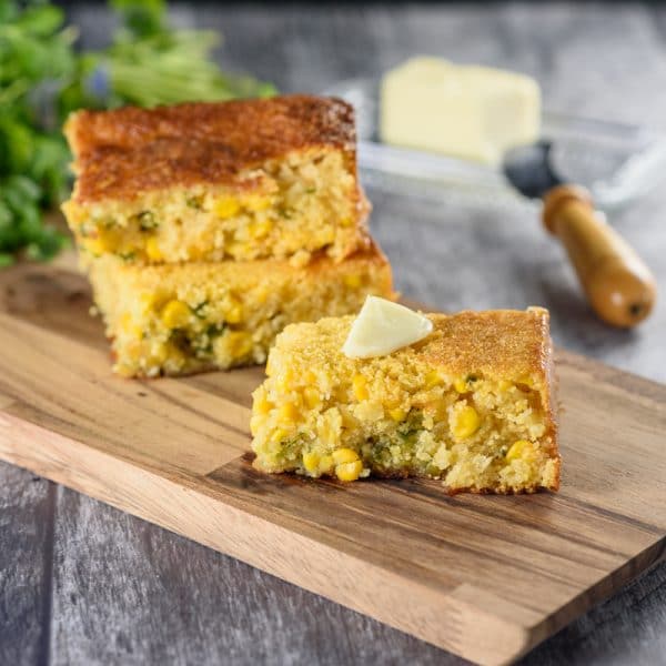spicy cornbread being served with a pat of butter