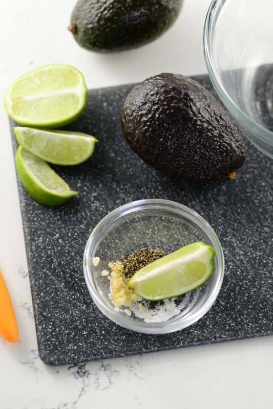 avocados and limes on a cutting board