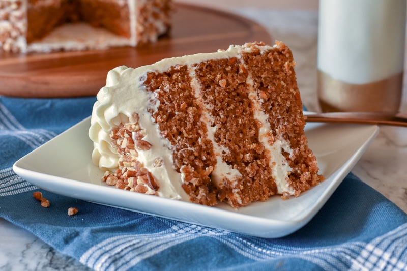 three-layer cake slice frosted with vegan cream cheese frosting