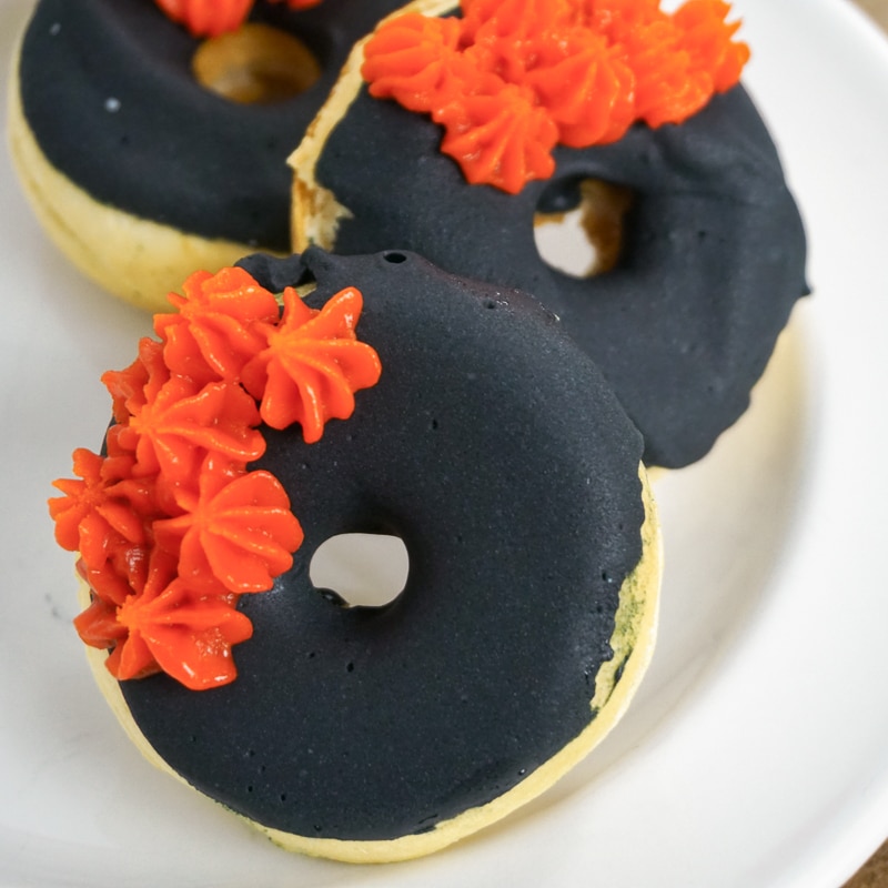 vegan doughnuts with chocolate glaze on a white plate