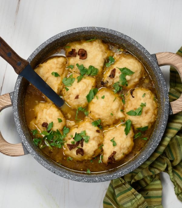 vegan dumplings being served in a mushroom broth