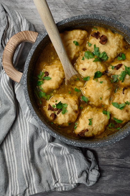 vegan dumpling soup being served in a big pot 