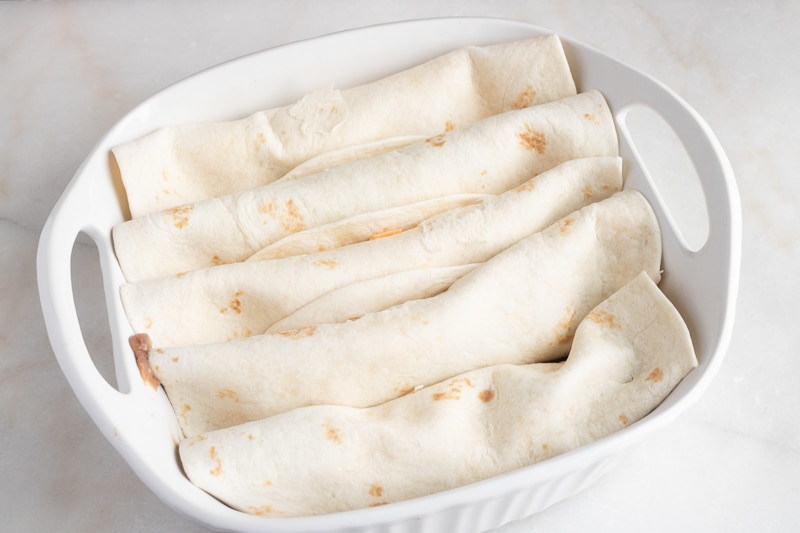 vegan enchilada in a baking dish ready to be baked