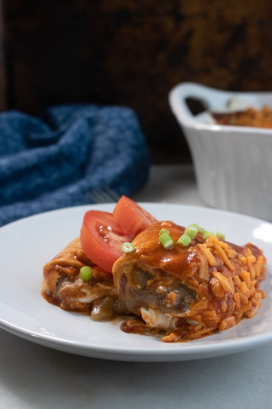 vegan enchiladas with black beans on a white plate