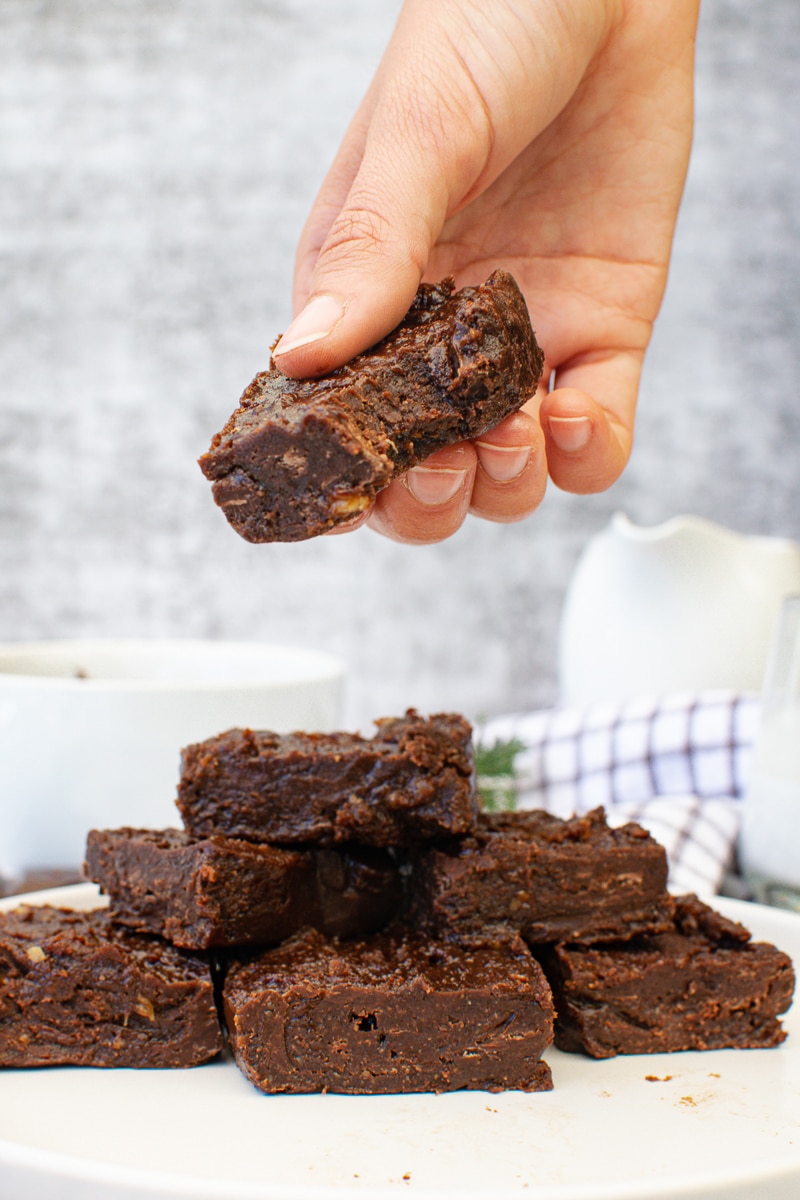 stack of vegan fudge, one piece with a bite taken out