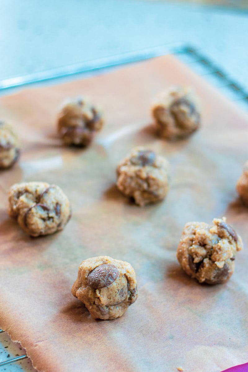 chocolate chip cookie dough balls on a baking sheet