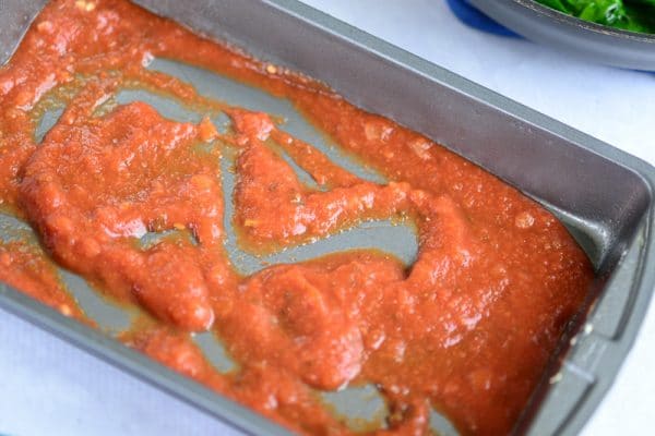 tomato sauce in baking dish for vegan lasagna