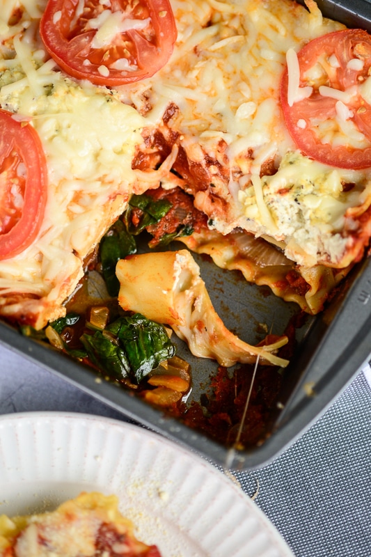 vegan lasagna being served in a baking dish