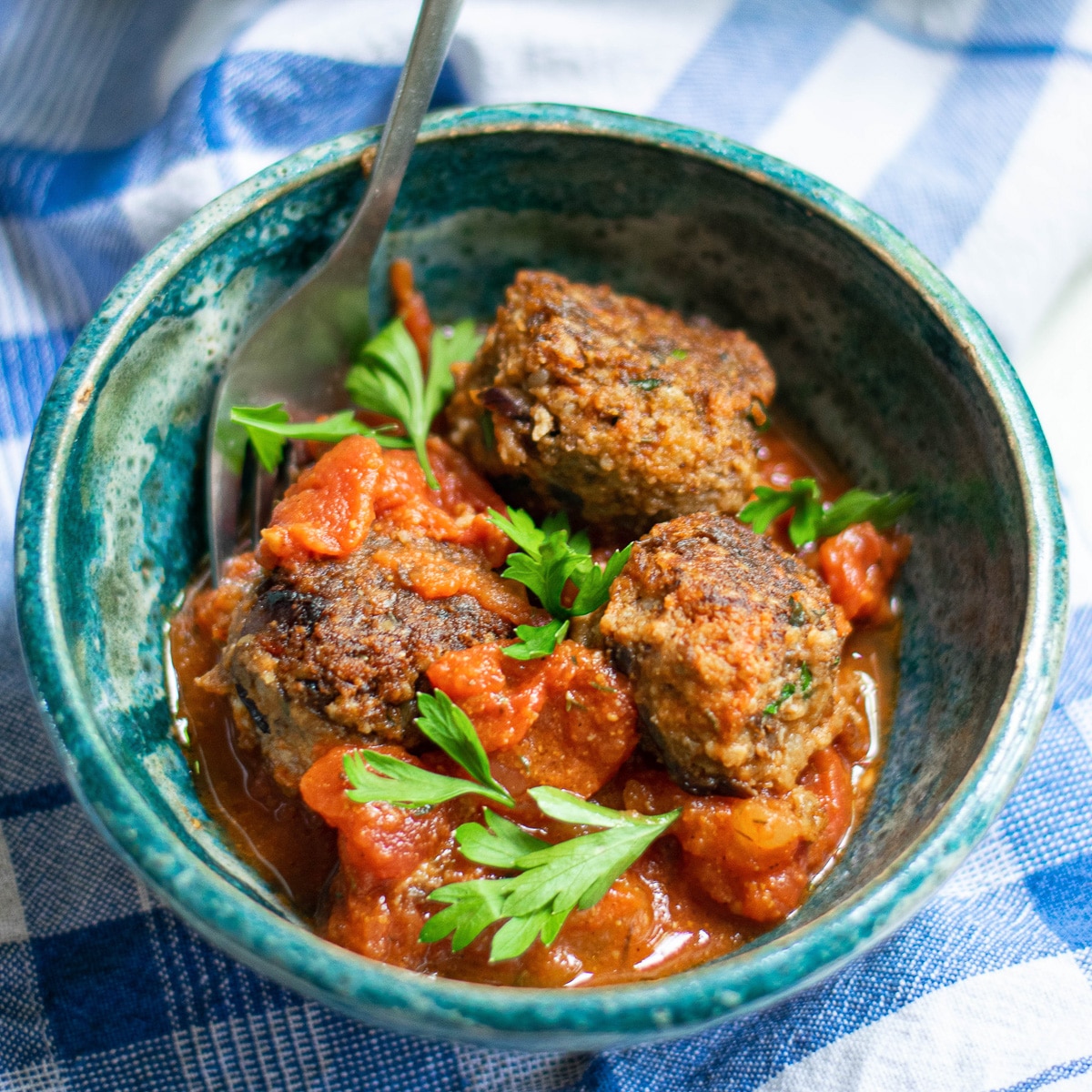 vegan lentil meatballs being served in a blue dish