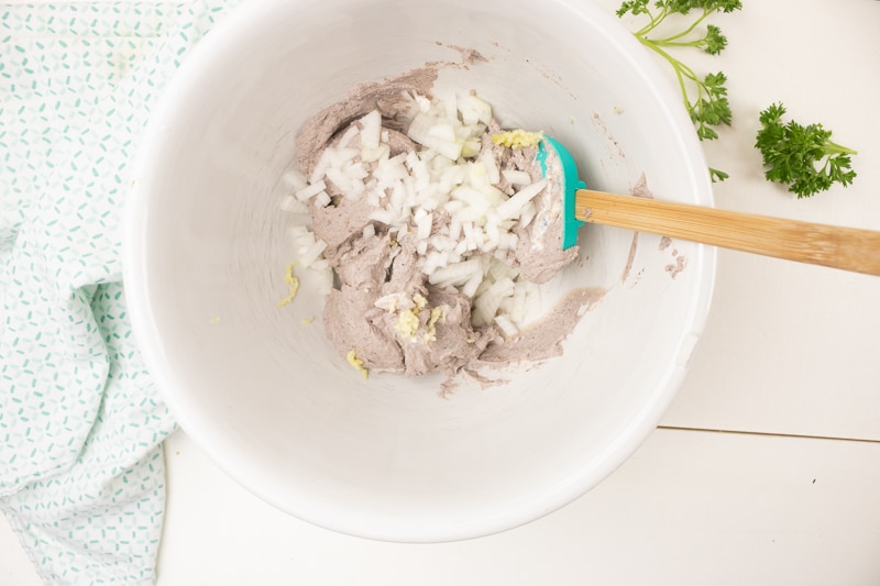 mixing tofu and black beans for vegan meatballs