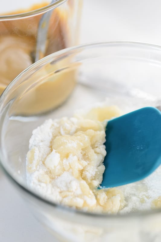 mixing batter in a bowl for vegan peanut butter cookies
