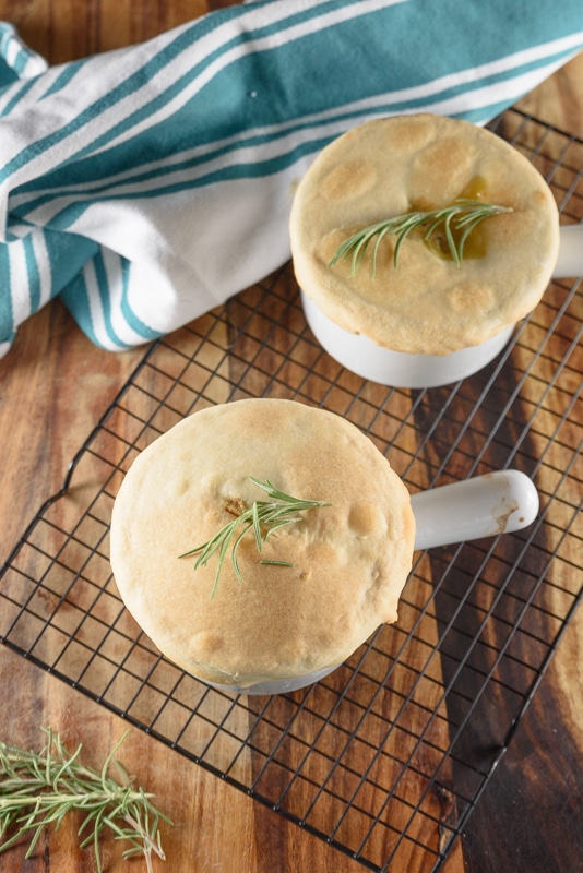 veggie pot pies topped with rosemary on a cooling rack