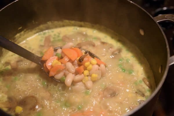 stirring the veggies and broth for vegan pot pie filling