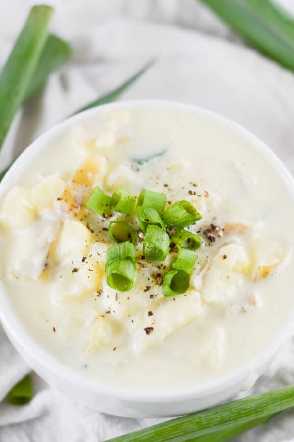 vegan potato soup being served in a white bowl