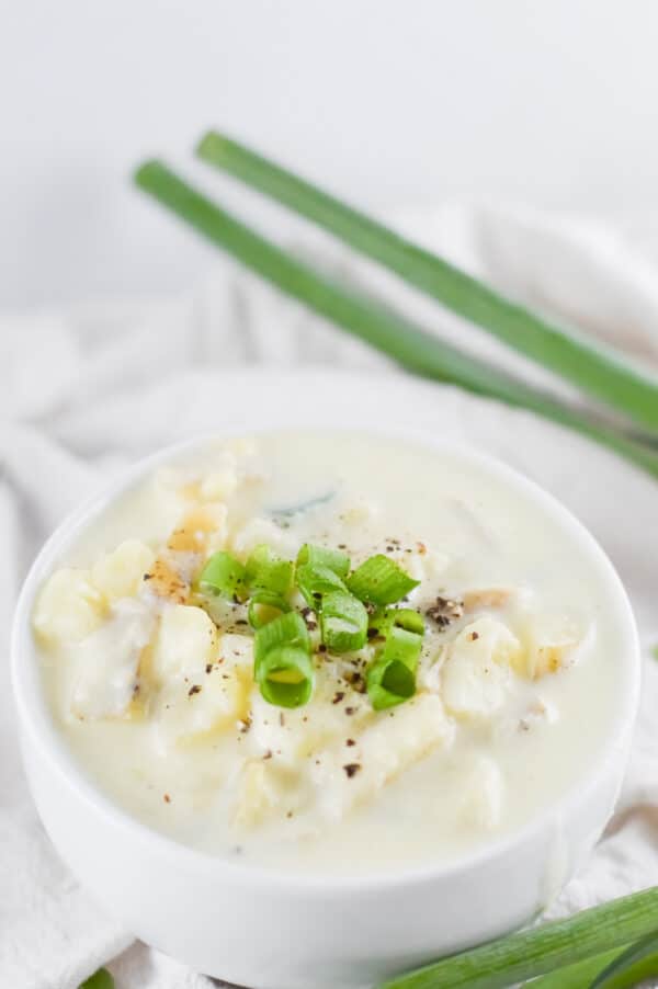 bowl of vegan potato soup topped with scallions