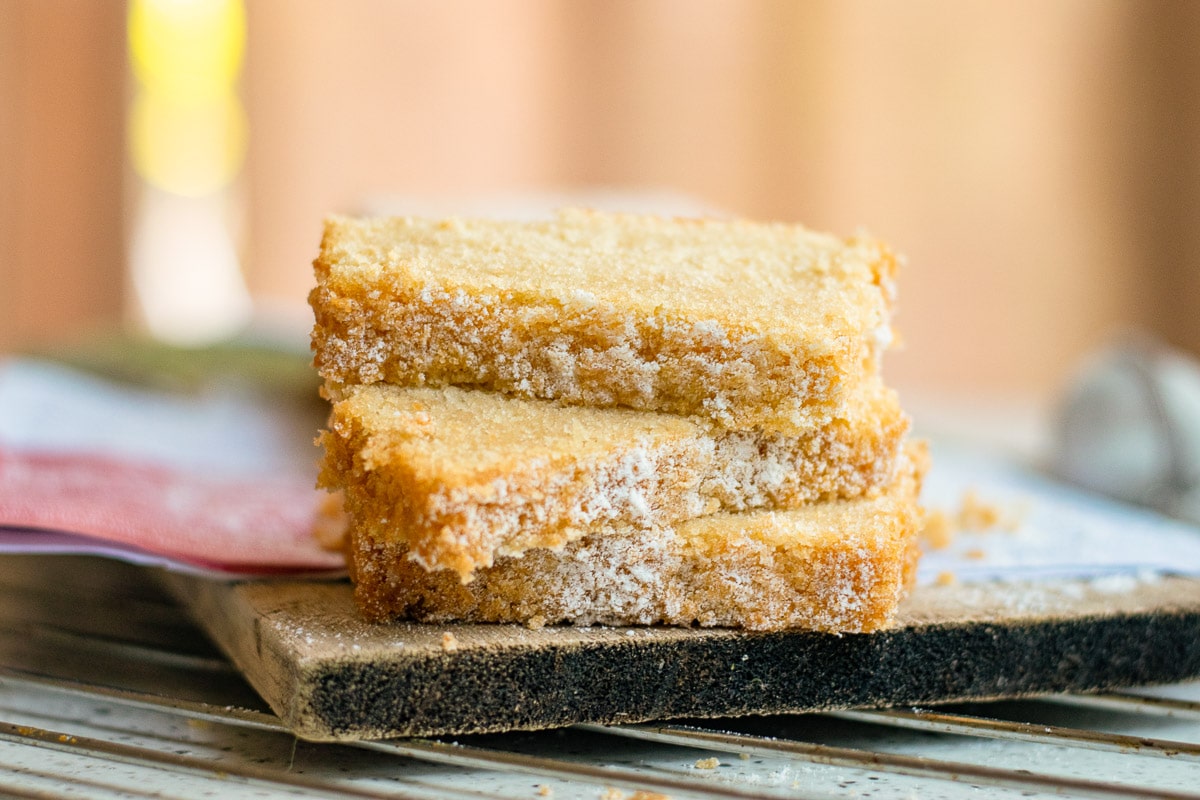 vegan pound cake slices piled on a cutting board