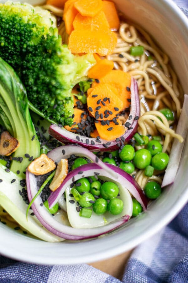 vegan ramen recipe packed with flavor and crunchy veggies, being served in a white bowl