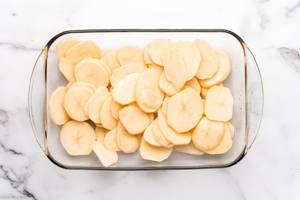 layering the potatoes in the pan