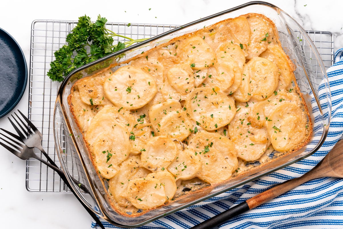 pan of vegan scalloped potatoes being served