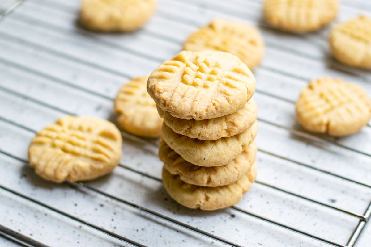  vegan shortbread cookies piled on a cooling rack