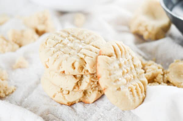 vegan sugar cookies stacked on a white plate